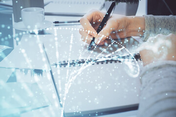 Fototapeta premium DNA theme hologram over woman's hands writing background. Concept of education. Double exposure