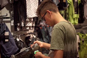 young boy shopping in a clothing store