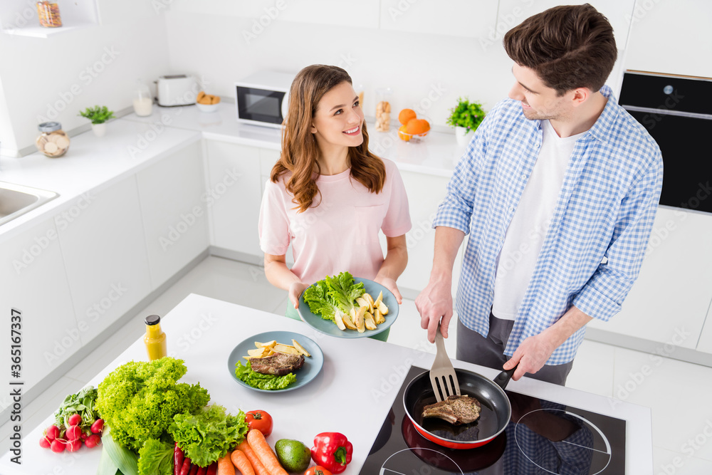 Sticker Top above high angle view photo of two people spouses man woman have dream chef cuisine weekend man hold spatula frying pan yummy barbecue meat girl want serve plate in kitchen house indoors