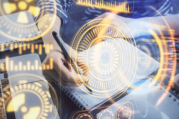 Tech theme hologram over woman's hands taking notes background. Concept of hightech. Double exposure