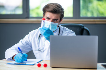 profesional doctor working at his desk collecting data