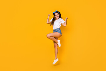 Fototapeta na wymiar Full size photo of cheerful crazy girl win spring discount lottery jump raise fists wear good look lifestyle outfit shoes blue headband isolated over bright color background