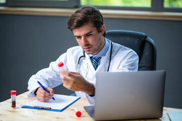 profesional doctor working at his desk collecting data