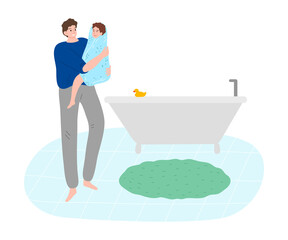 Young father holding his son in towel after bath in bathroom