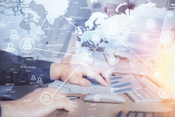 Social network theme hologram with businessman working on computer on background. Multi exposure.