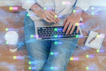 Multi exposure of data internet theme hologram with man working on computer on background. Concept...