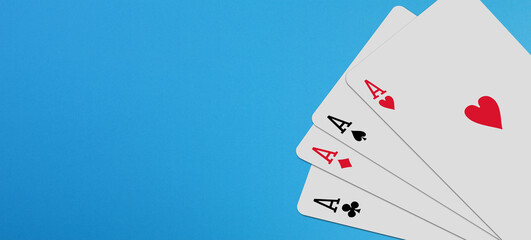 Four aces playing cards with copy space on blue background