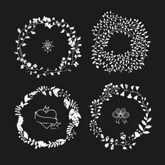 Grunge style vector wreaths on black background. Floral wreaths and round frames vintage design