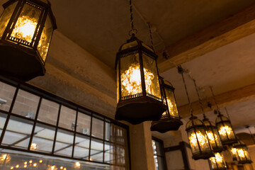 decoration and interior concept - lantern lamps hanging at restaurant