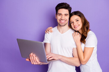 Photo pretty lady handsome guy couple good mood hold notebook hands watch movie film together spend free time leisure wear casual white t-shirts isolated purple pastel color background
