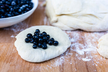 Dough for homemade scones with freshly picked blueberries.