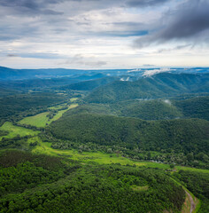 Fototapeta na wymiar Aerial drone view with green forests and hills overgrown with lush vegetation in the spring time, Strandzha Mountain, Bulgaria