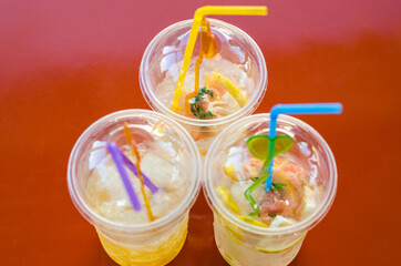 Summer refreshments. Three glasses of lemonade are on the table. Selective focus.