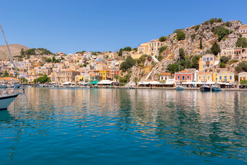 Fototapeta na wymiar The beautiful island of Symi with a turquoise bay and colorful architecture Dodecanese, Greece