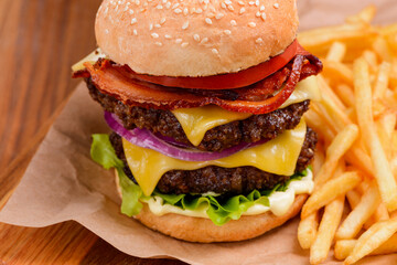 Close up on double cheeseburger and French fries
