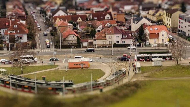 Aerial view of the Divoka Sarka tram stop and Ruzyne residential district in Prague. Usual traffic on the Evropska avenue, cars, busses and trams. People walking on the sidewalks. Hyperlapse video.