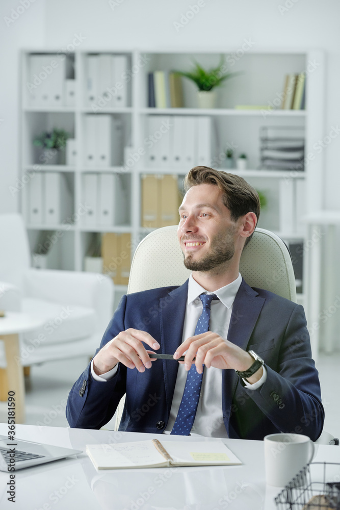 Aufkleber smiling handsome businessman with stubble sitting at desk and listening to business partner while me