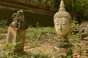 Fototapeta na wymiar Ancient Wreckage Buddha Statue at Wat U Mong (Tunnel) Chiang Mai province, Thailand.