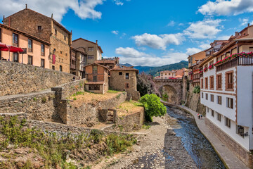 Fototapeta premium Views of the medieval town of Potes with hanging houses and the Deva river, Cantabria, Spain.