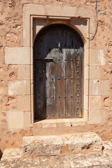 Antique wooden door in a stone house.