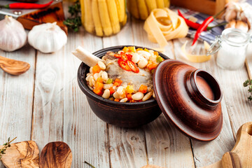 Stewed vegetables with beans and beef bone in pot
