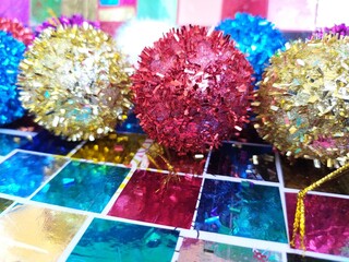 Colorful shiny christmas balls decorations on a colorful background