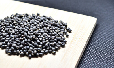 Raw black Urad dal or vigna mungo on a wooden board