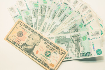 ruble and dollar banknotes lie on a white background