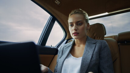 Angry businesswoman having video call at car. Confident woman using computer