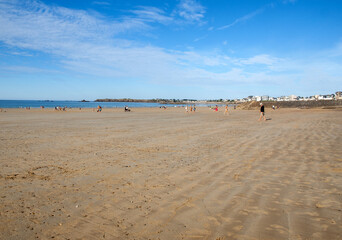  Romantic walk of people before sunset on the picturesque beach of Saint Malo. Brittany, France
