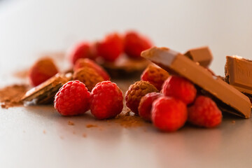 raspberries with chocolate on gray background chocolate