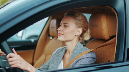 Closeup business woman dancing at automobile. Businesswoman sitting in new car