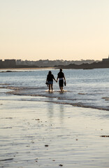 Romantic walk of a couple in love on the beach in Saint Malo. Brittany, France