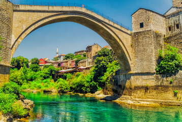 A person is standing at famous Old Bridge over river Neretva in Mostar, Bosnia and Herzegovina.
