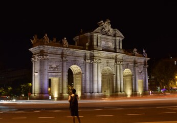 Through the streets of Madrid at night with the Puerta de Alcala at night