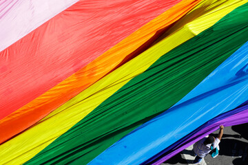 A reveler hold a giant rainbow flag during the annual gay pride parade in Paulista avenue, Sao Paulo, Brazil.