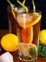 Two glasses of summer ice tea with lemon and mint. Refreshing citrus drink