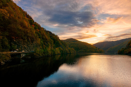 sunset on the tarnita lake in romania. beautiful nature scenery in autumn at dusk. gorgeous sky with glowing clouds