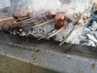 Shashlik preparing on a barbecue grill over charcoal. Shashlik or Shish kebab popular in Eastern Europe.