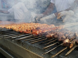 Shashlik preparing on a barbecue grill over charcoal. Shashlik or Shish kebab popular in Eastern Europe.