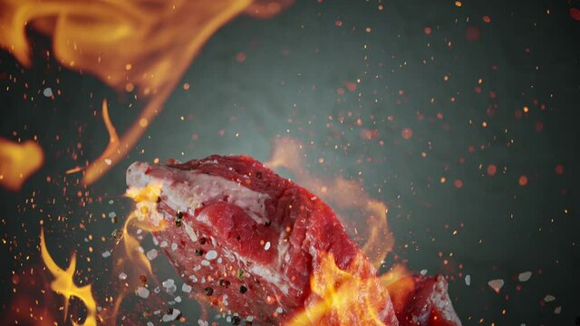 Close-up of falling tasty beef steak, super slow motion, filmed on high speed cinematic camera at 1000 fps.
