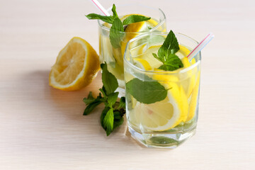 Lemonade or mojito cocktail with lemon and mint