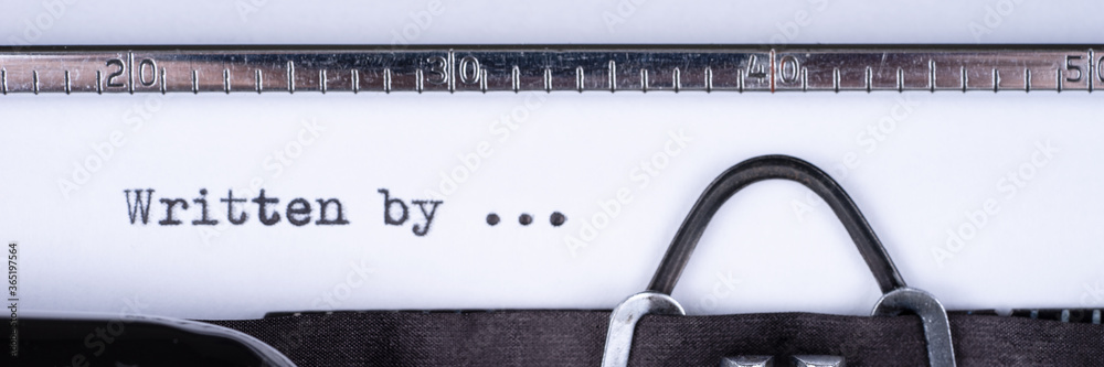 Fototapete written by... text written with a old typewriter