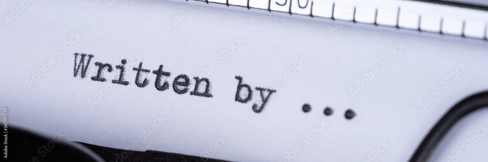 Fototapete written by... text written with a old typewriter