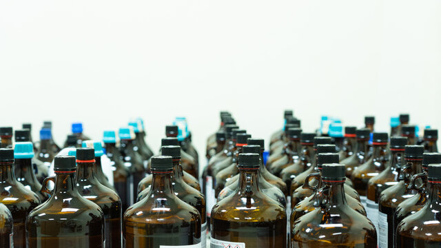 Group of bottles contain chemical hazardous waste in quarantine area and waiting disposal, concept of chemical waste management and environment concern for chemical waste contamination