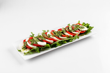 Side view on isolated classic caprese salad 
