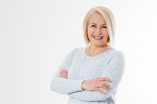 Happy beautiful close up portrait middle age blonde woman. Mid aged healthy female isolated on white background with copy space. Menopause and healthcare. Mature lady wrinkled face. Folded hands