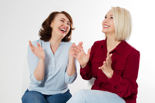 Happy menopause concept. Two healthy and beautiful middle aged women isolated on white background. Woman support woman. Closeup faces and skincare makeup.