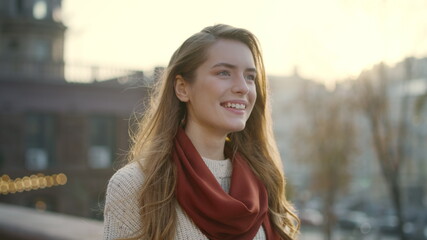 Sweet woman smiling on street. Portrait of cheerful girl walking outdoors.