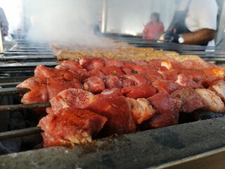 Shashlik preparing on a barbecue grill over charcoal. Shashlik or Shish kebab popular in Eastern Europe.